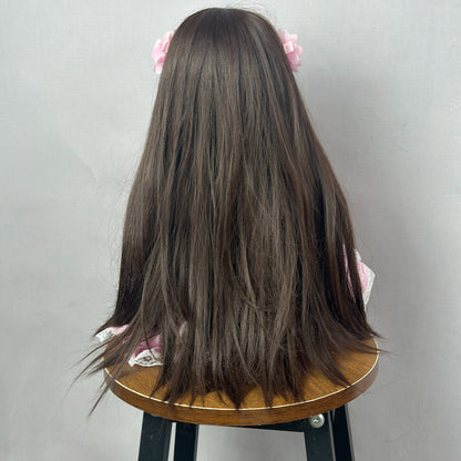 Poupée Reborn Betty de 55 cm yeux ouverts cheveux longs bruns robe rose