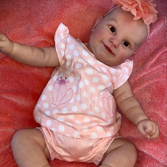 Poupée reborn Maddie corps souple de 60 cm yeux ouverts vêtue d'une robe rose à pois