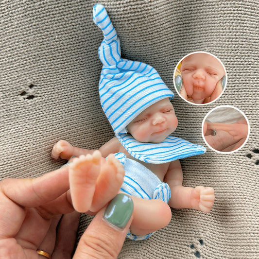 Poupée reborn miniature Pascale de 15 cm yeux fermés en silicone vêtue d'une tenue à rayures bleues