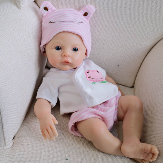 Bébé reborn de 30 cm en silicone souple yeux bleus fille vêtue de vêtements roses