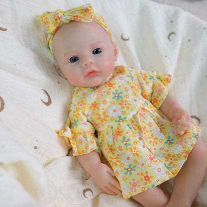 Bébé reborn de 30 cm en silicone souple fille vêtue d'une robe à fleurs jaunes