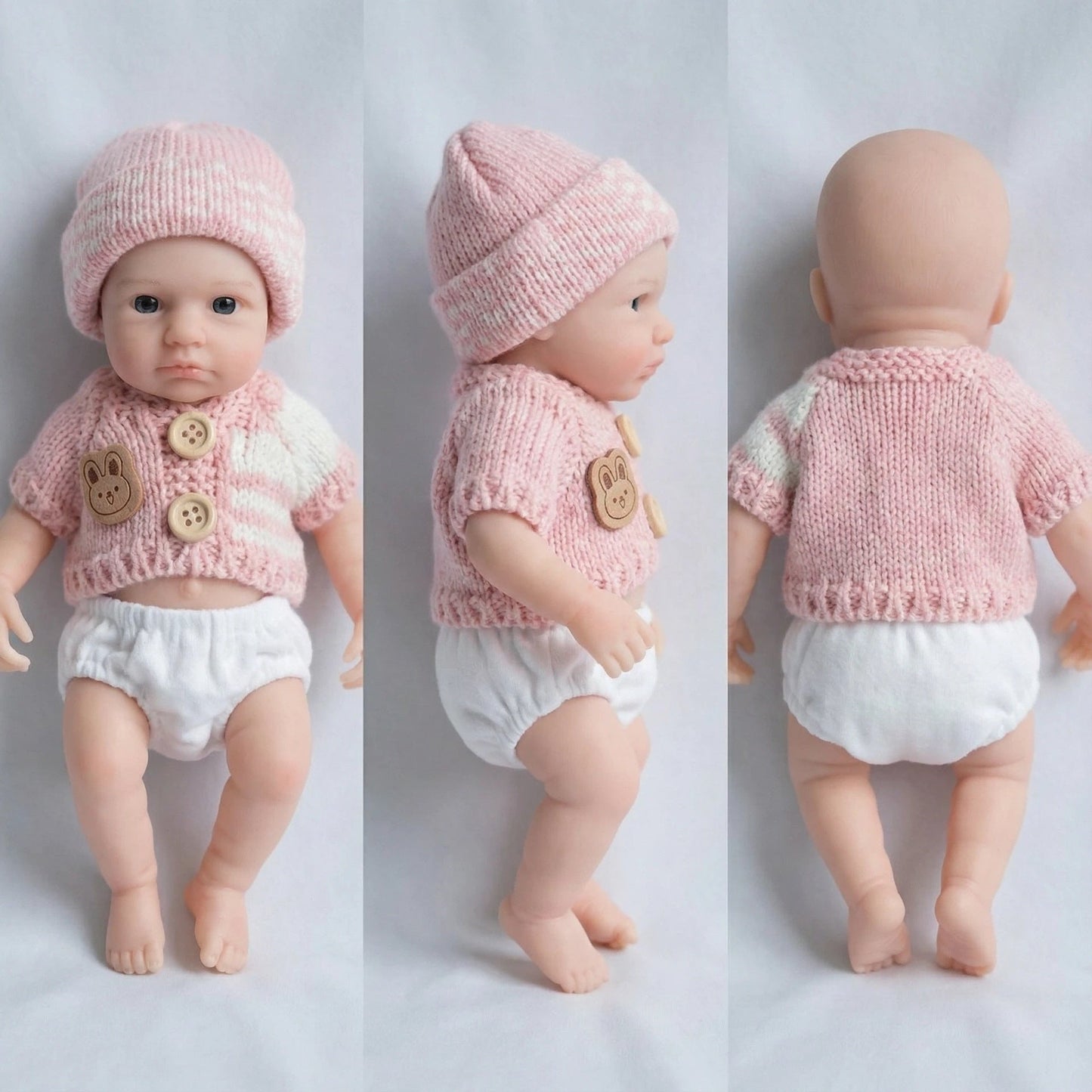 Bébé reborn Loulou fille de 20 cm yeux ouverts entièrement en silicone vêtue d'un pull rose