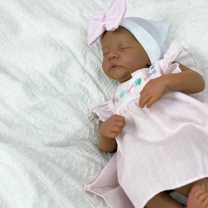 Bébé Reborn Levi de 48cm yeux fermés peau foncée corps doux en robe rose