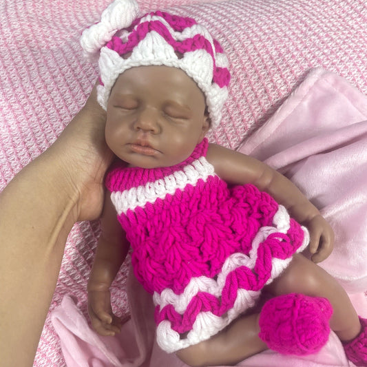 Poupée reborn Loulou en silicone réaliste de 30cm endormie à la peau foncée et vêtue de tricots