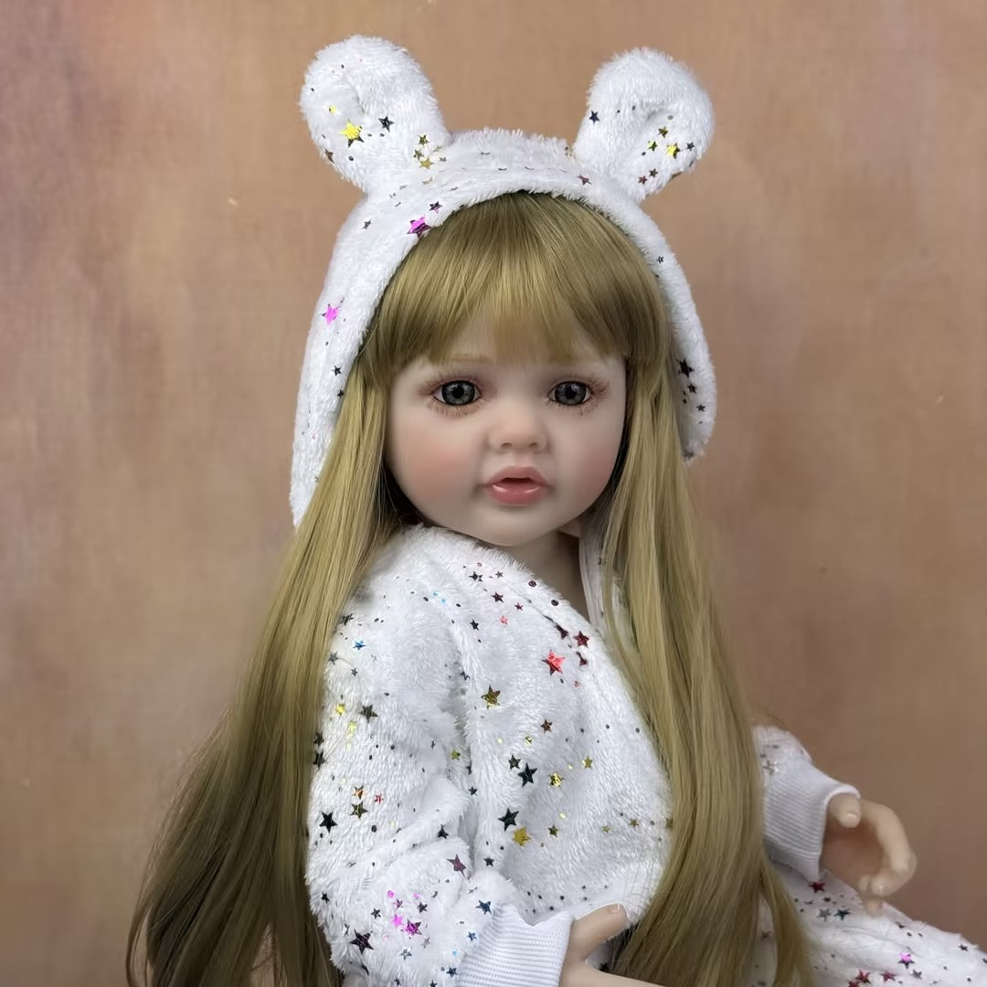 Bébé reborn Betty 55 cm yeux ouverts longs cheveux blonds en combinaison à étoiles