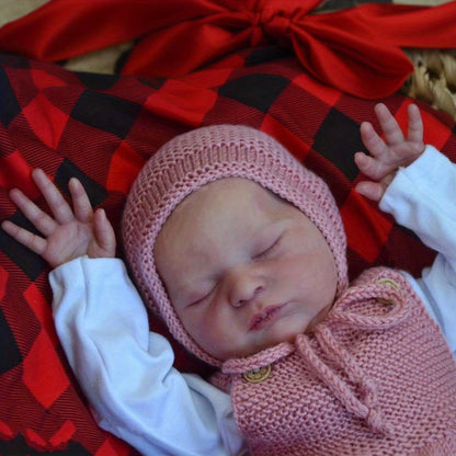 Poupée reborn Laura endormie corps souple de 50 cm vêtue d'un pull rose