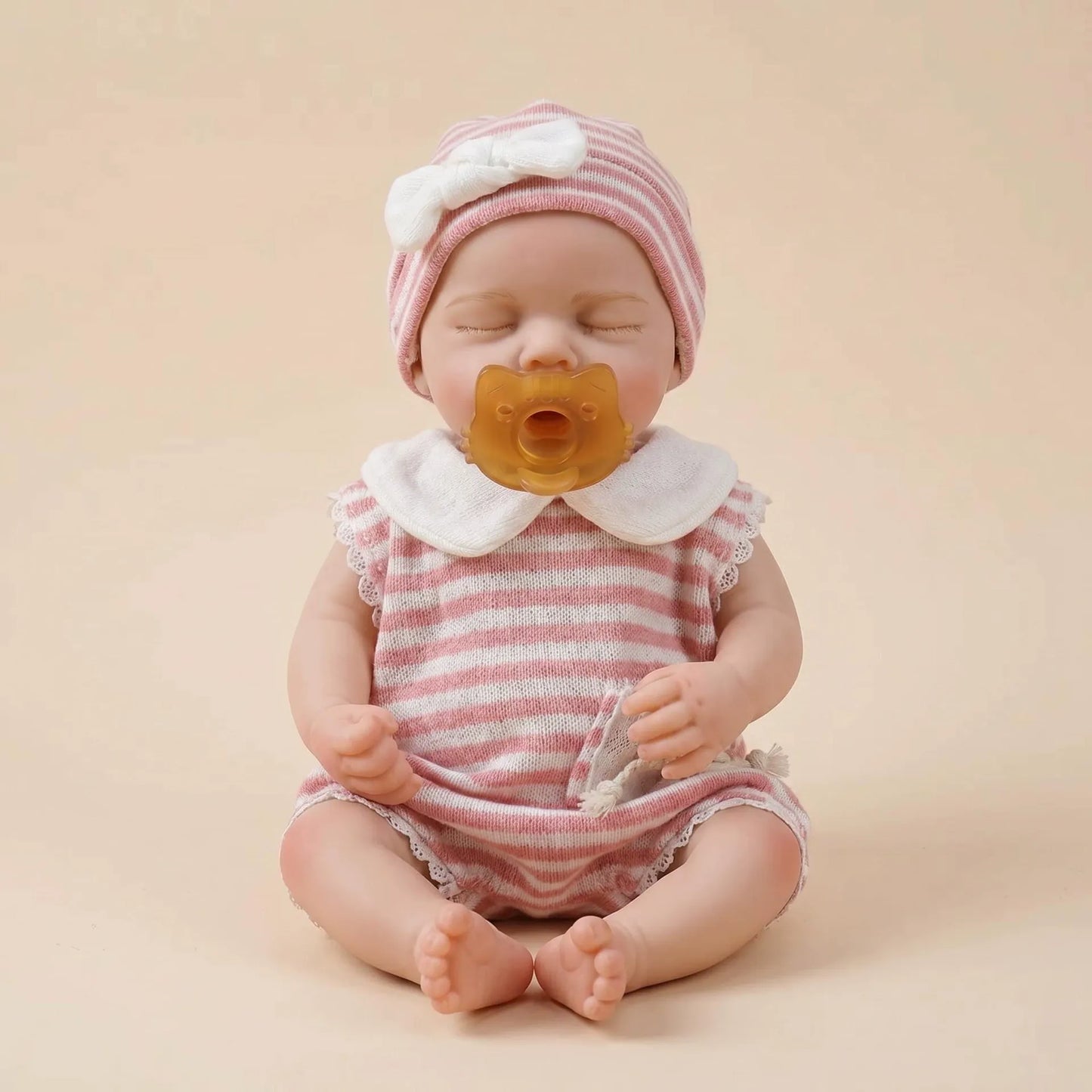 Bébé reborn Loulou de 30cm en silicone intégral fille vêtue d'une tenue à rayures roses