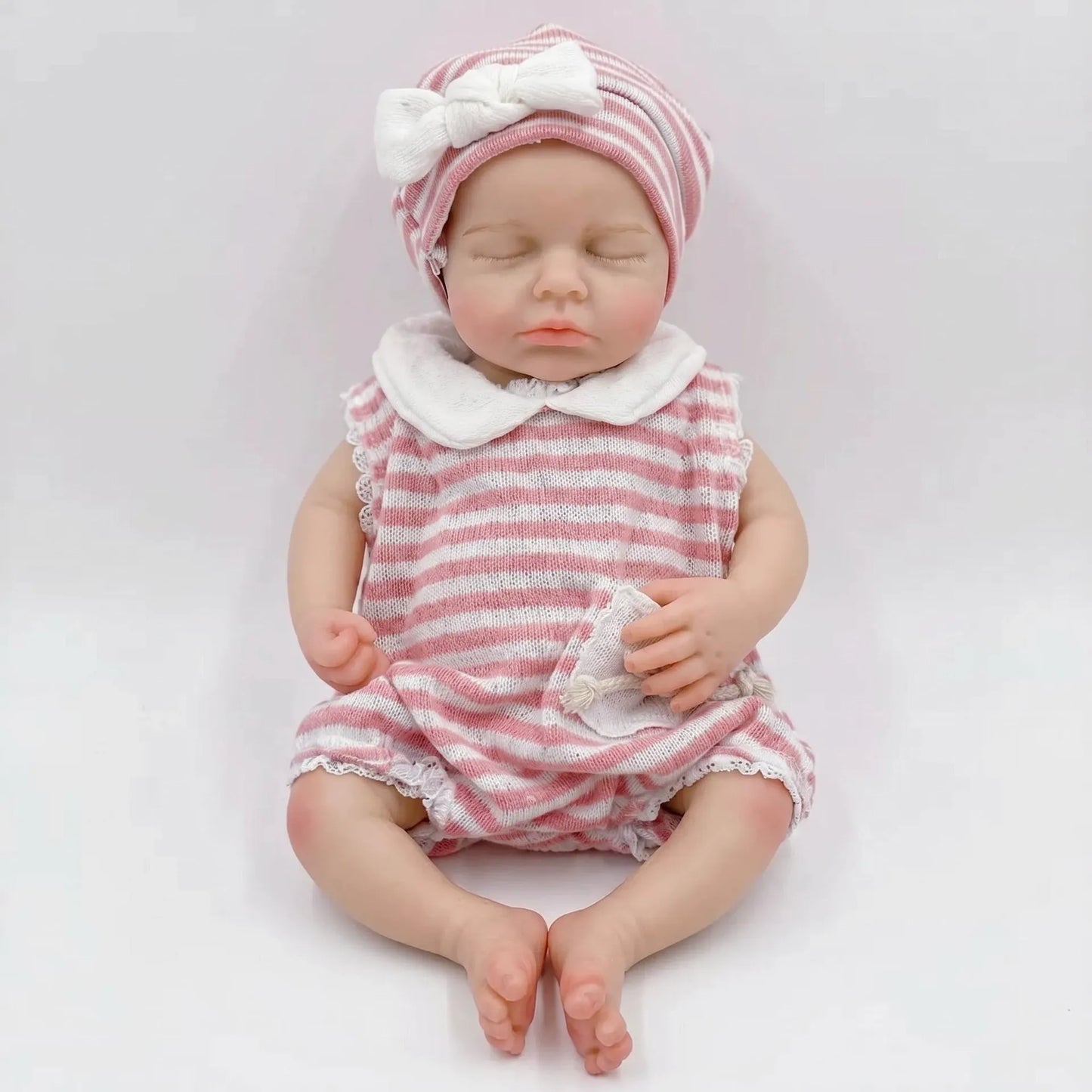 Bébé reborn Loulou de 30cm en silicone intégral fille vêtue d'une tenue à rayures roses