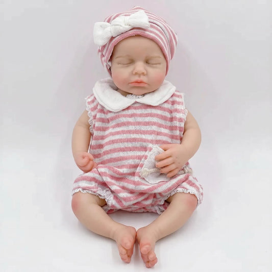 Bébé reborn Loulou de 30cm en silicone intégral fille vêtue d'une tenue à rayures roses